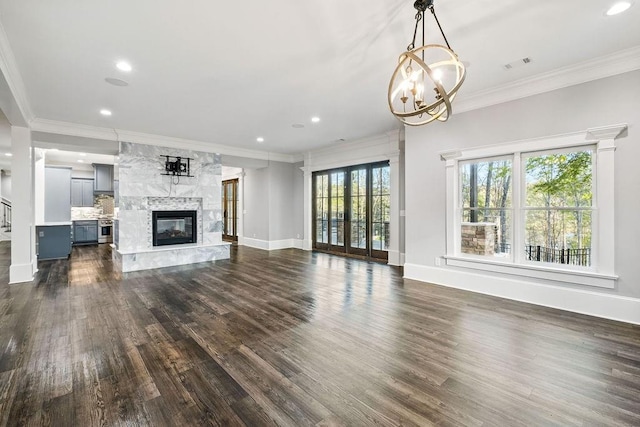 6225 Random Winds Blf, Gainesville, GA 30506 - unfurnished living room with dark wood-type flooring, a high end fireplace, a chandelier, ornamental molding, and recessed lighting