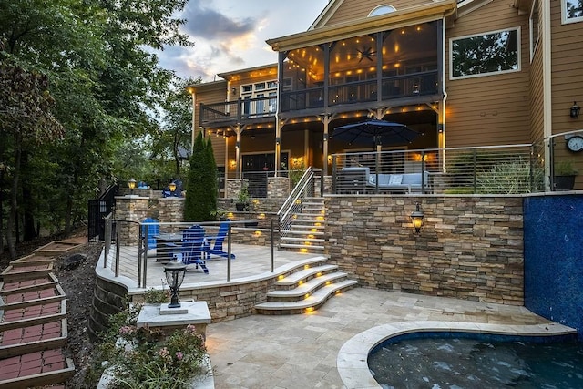 6225 Random Winds Blf, Gainesville, GA 30506 - back of house at dusk featuring stairs, a patio, and a balcony