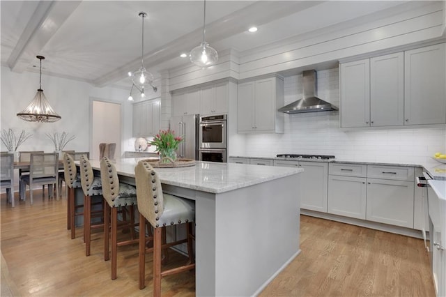 2620 Middle Coray Cir, Marietta, GA 30066 - kitchen with beam ceiling, light wood-style floors, appliances with stainless steel finishes, wall chimney exhaust hood, and backsplash