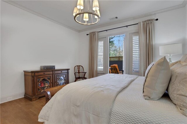 2620 Middle Coray Cir, Marietta, GA 30066 - bedroom with visible vents, baseboards, ornamental molding, wood finished floors, and a notable chandelier