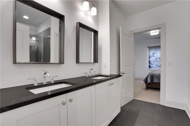 2620 Middle Coray Cir, Marietta, GA 30066 - bathroom featuring a sink, baseboards, double vanity, and tile patterned floors