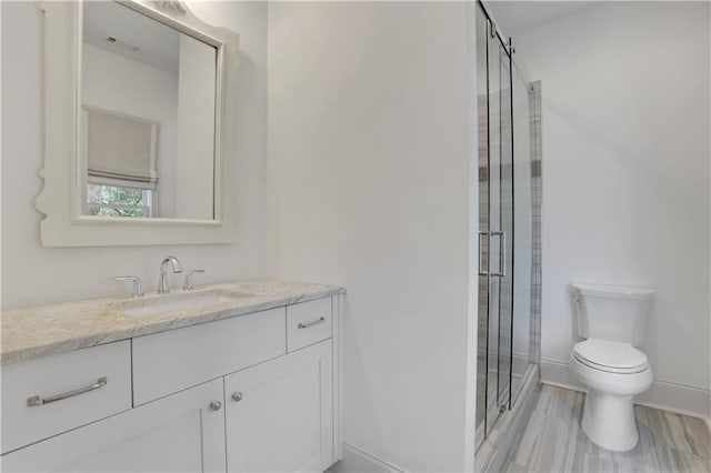 2620 Middle Coray Cir, Marietta, GA 30066 - full bathroom featuring vanity, baseboards, visible vents, a stall shower, and toilet