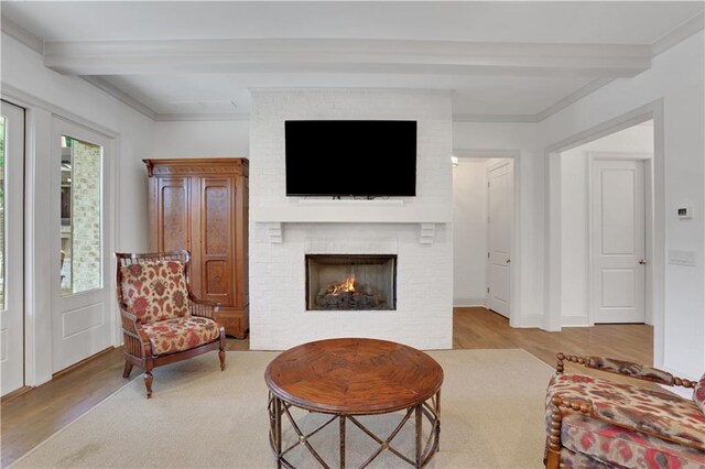 2620 Middle Coray Cir, Marietta, GA 30066 - living area with beamed ceiling, plenty of natural light, a brick fireplace, and wood finished floors