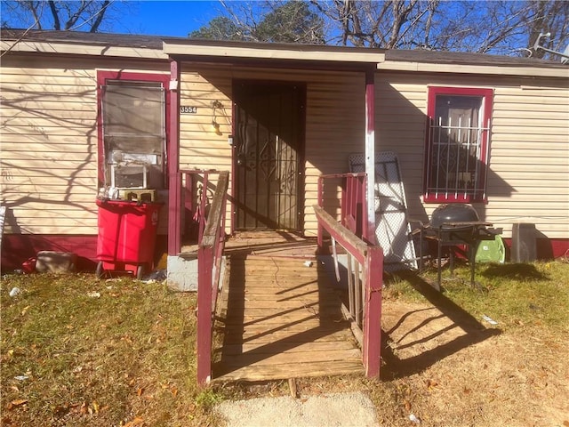 view of exterior entry featuring a yard