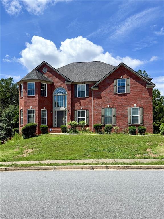 1202 Tupelo Chase Ct, Auburn, GA 30011 - view of front of home featuring brick siding and a front yard