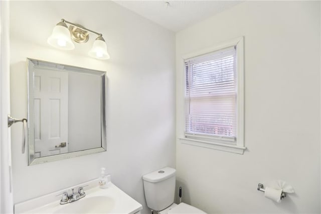 bathroom with toilet and vanity