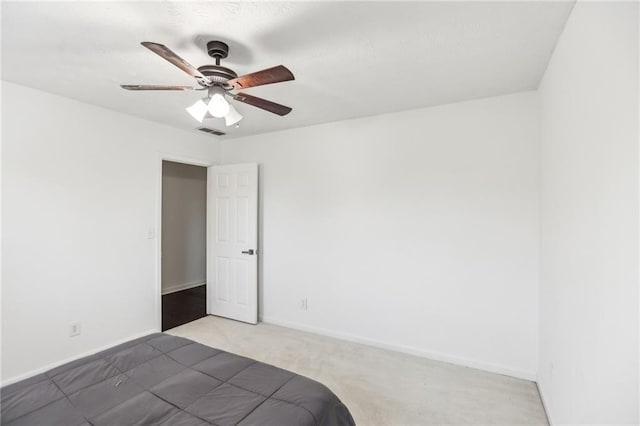 unfurnished bedroom with ceiling fan and carpet