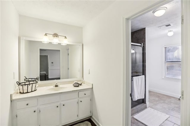 bathroom featuring vanity, a premium fireplace, and a textured ceiling