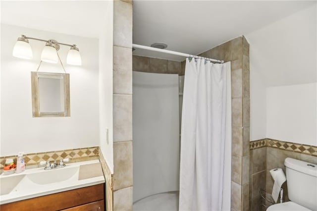 bathroom featuring toilet, vanity, tile walls, and curtained shower