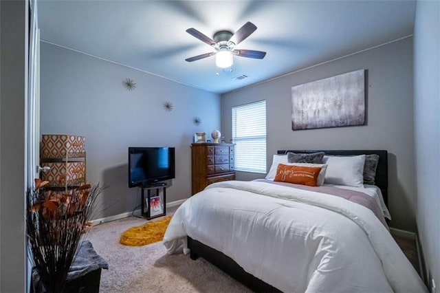 bedroom with carpet flooring, visible vents, a ceiling fan, and baseboards