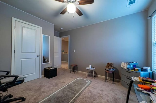 carpeted home office featuring visible vents, ceiling fan, and baseboards