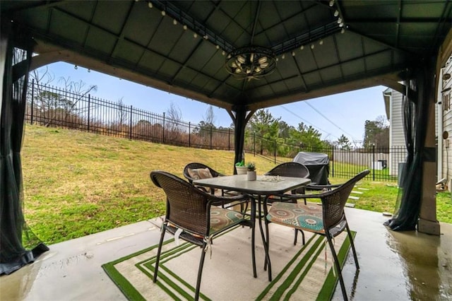 view of patio / terrace featuring a gazebo, outdoor dining space, grilling area, and a fenced backyard