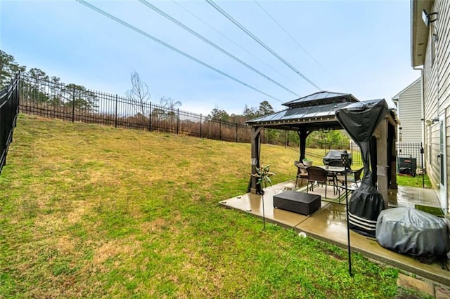 view of yard with a gazebo, a fenced backyard, and a patio area