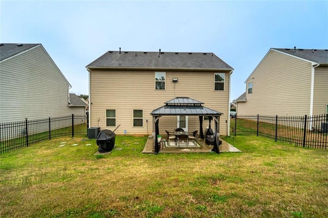 rear view of property with a gazebo, central AC unit, a fenced backyard, a yard, and a patio