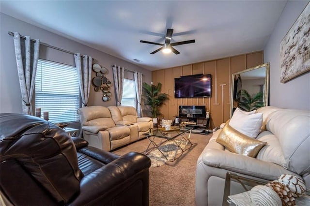 carpeted living room featuring a ceiling fan