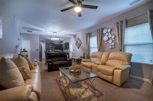 living room with light colored carpet, ceiling fan with notable chandelier, visible vents, and baseboards