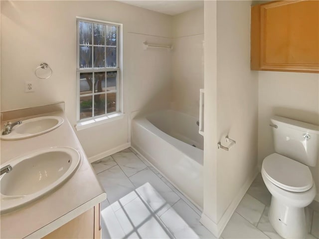 full bath featuring marble finish floor, baseboards, a sink, and toilet