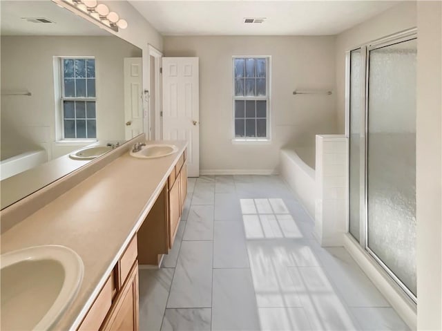 bathroom featuring visible vents, a sink, and double vanity