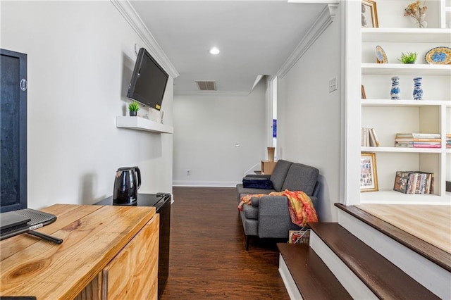 living area with ornamental molding and dark hardwood / wood-style floors