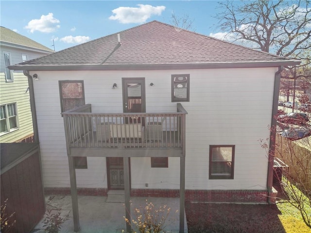 rear view of property featuring a patio area and a balcony