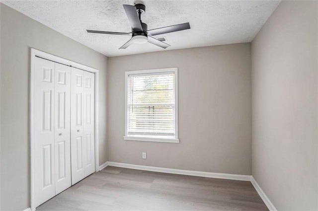 2945 Catalina Dr, Decatur, GA 30032 - unfurnished bedroom with a textured ceiling, a closet, baseboards, and wood finished floors