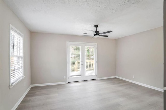 2945 Catalina Dr, Decatur, GA 30032 - unfurnished room with french doors, a textured ceiling, baseboards, and wood finished floors