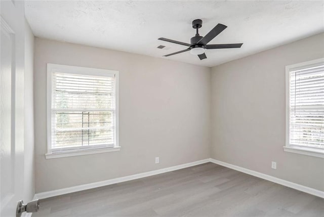 2945 Catalina Dr, Decatur, GA 30032 - unfurnished room featuring visible vents, wood finished floors, a ceiling fan, and baseboards