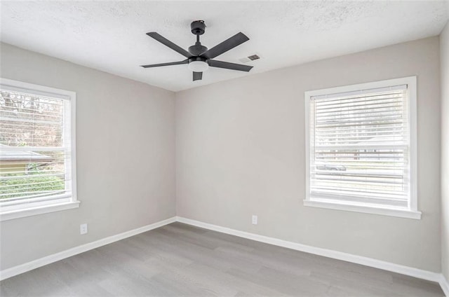 2945 Catalina Dr, Decatur, GA 30032 - unfurnished room with baseboards, visible vents, a ceiling fan, wood finished floors, and a textured ceiling