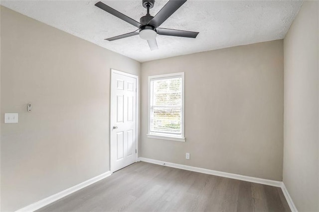 2945 Catalina Dr, Decatur, GA 30032 - spare room with a textured ceiling, ceiling fan, wood finished floors, and baseboards