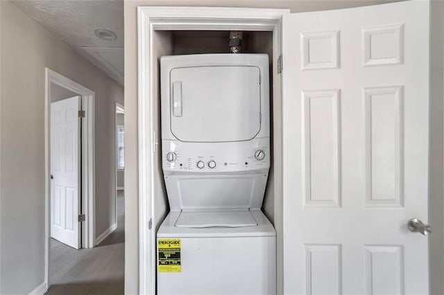 2945 Catalina Dr, Decatur, GA 30032 - clothes washing area with stacked washer / drying machine, laundry area, baseboards, and wood finished floors
