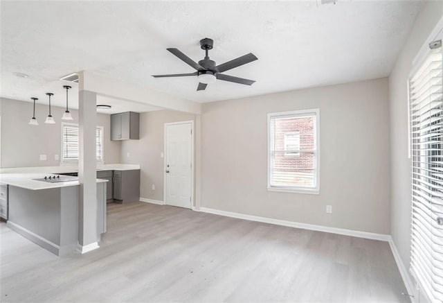 2945 Catalina Dr, Decatur, GA 30032 - unfurnished living room with light wood-style floors, ceiling fan, a textured ceiling, and baseboards