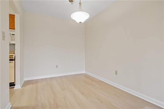 unfurnished room with light wood-type flooring