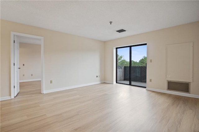 spare room with light hardwood / wood-style flooring