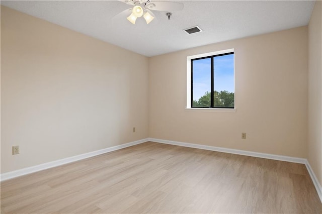 spare room featuring ceiling fan and light hardwood / wood-style floors