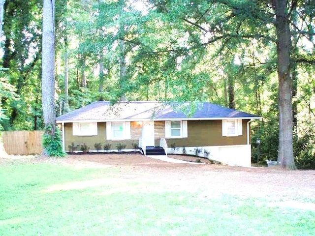 single story home featuring fence