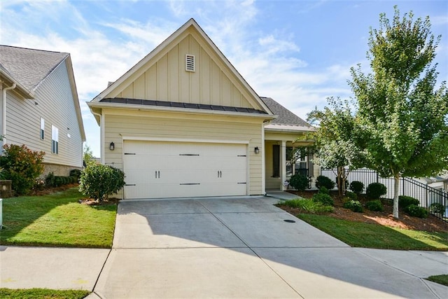 view of front of property with a front yard and a garage