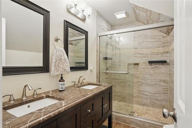 full bathroom featuring a shower stall and double vanity