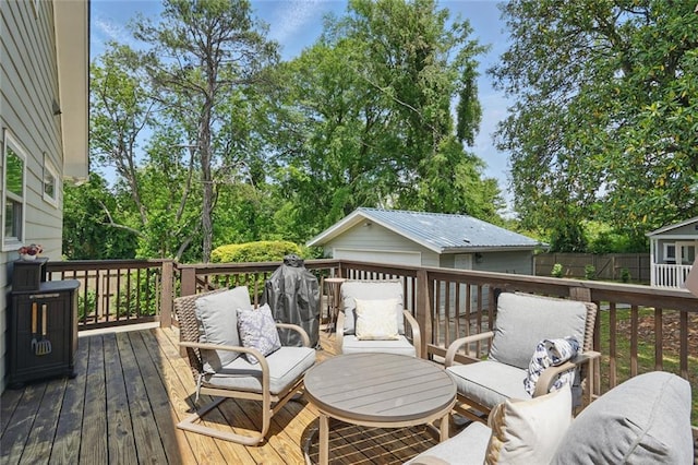 deck with an outbuilding, fence, and view of scattered trees
