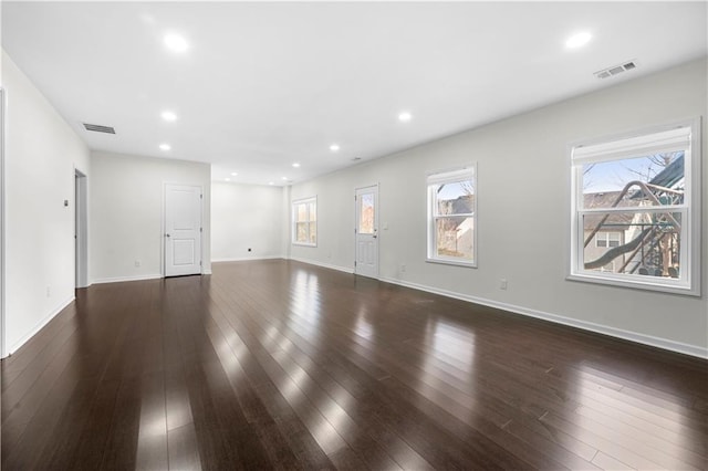 unfurnished living room featuring recessed lighting, visible vents, and dark wood finished floors