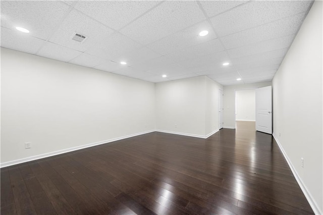 spare room with dark wood-type flooring, recessed lighting, baseboards, and visible vents