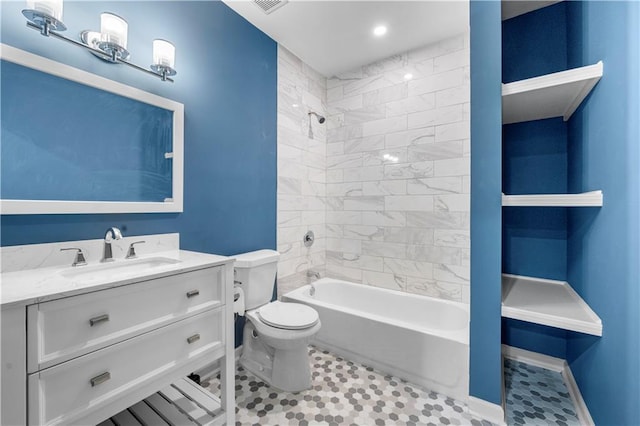 bathroom featuring baseboards, toilet, vanity, and bathing tub / shower combination