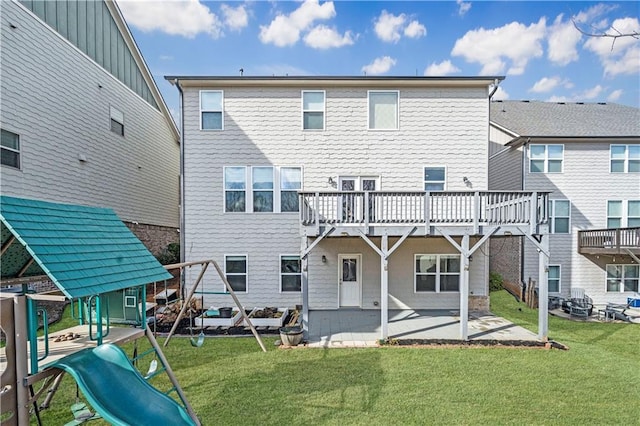 rear view of property featuring a patio area, a lawn, and a playground