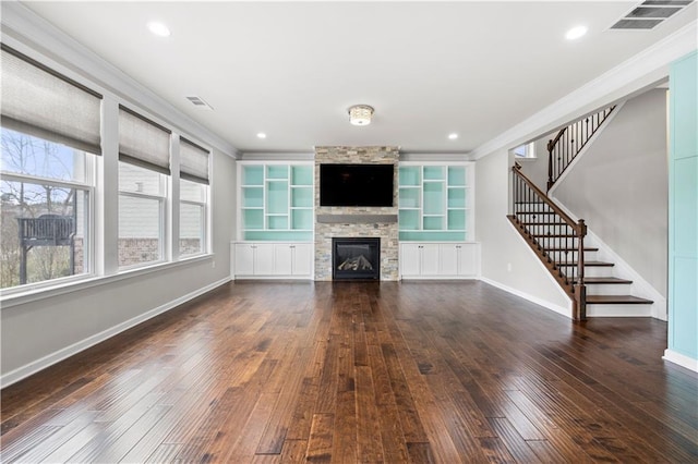 unfurnished living room featuring visible vents, a fireplace, baseboards, and hardwood / wood-style floors