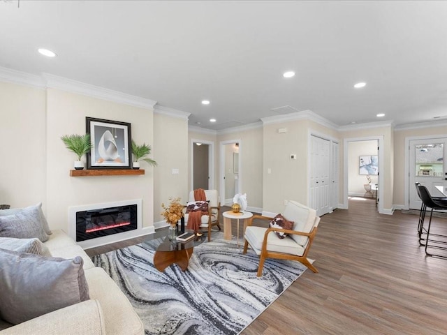 living room featuring hardwood / wood-style flooring and ornamental molding