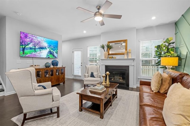 1098 Caruso Dr, Buford, GA 30518 - living area with ceiling fan, a wealth of natural light, wood finished floors, and a fireplace with flush hearth