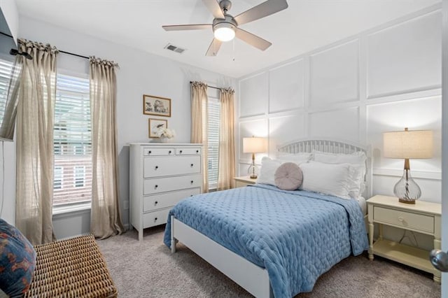 1098 Caruso Dr, Buford, GA 30518 - carpeted bedroom featuring ceiling fan, a decorative wall, and visible vents
