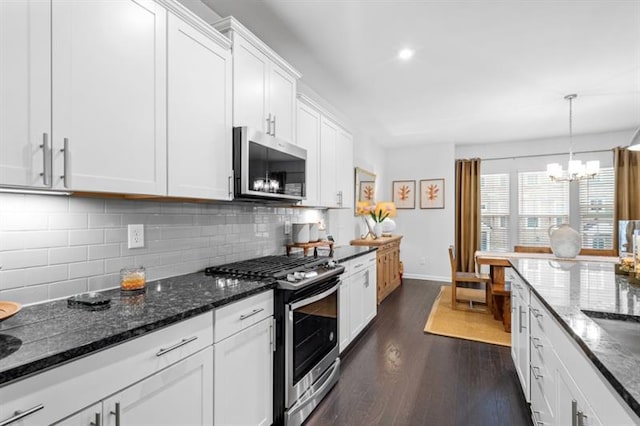 1098 Caruso Dr, Buford, GA 30518 - kitchen with white cabinets, appliances with stainless steel finishes, tasteful backsplash, and a notable chandelier