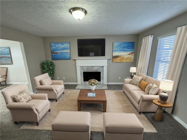 living room featuring a fireplace, a textured ceiling, and light carpet