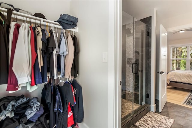 bathroom featuring an enclosed shower and tile patterned flooring