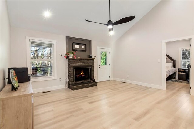 kitchen featuring a breakfast bar, hanging light fixtures, stainless steel appliances, and an island with sink